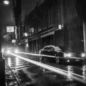 cars at night on a wet urban street