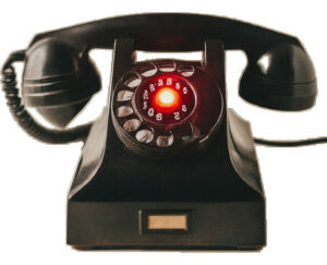 black deskset telephone with red light in middle of dialer