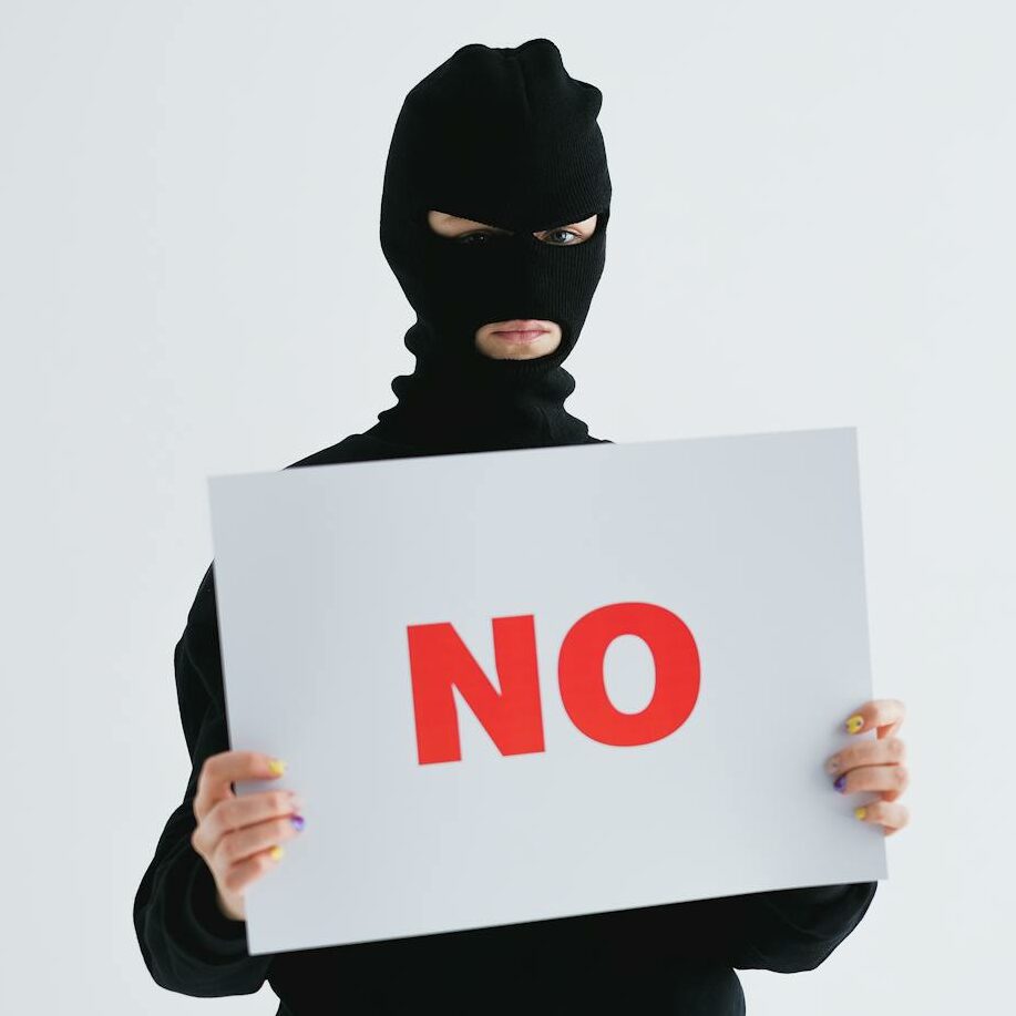 A Person in a Mask Holding a Sign